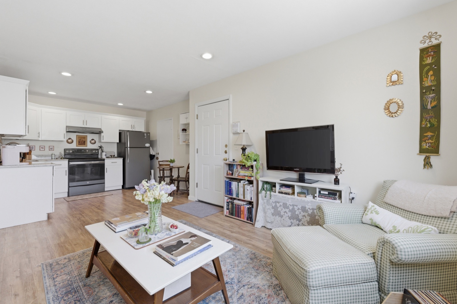 Open-concept living room and kitchen at 256 Parker Hill Ave, Unit 11